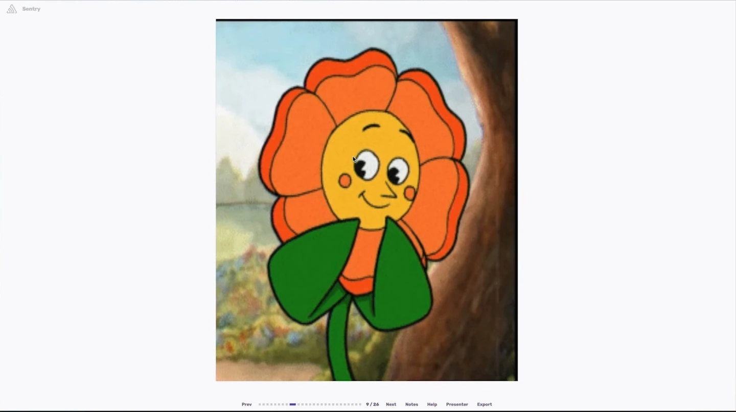 A smiling cartoon flower with orange petals and green leaves.