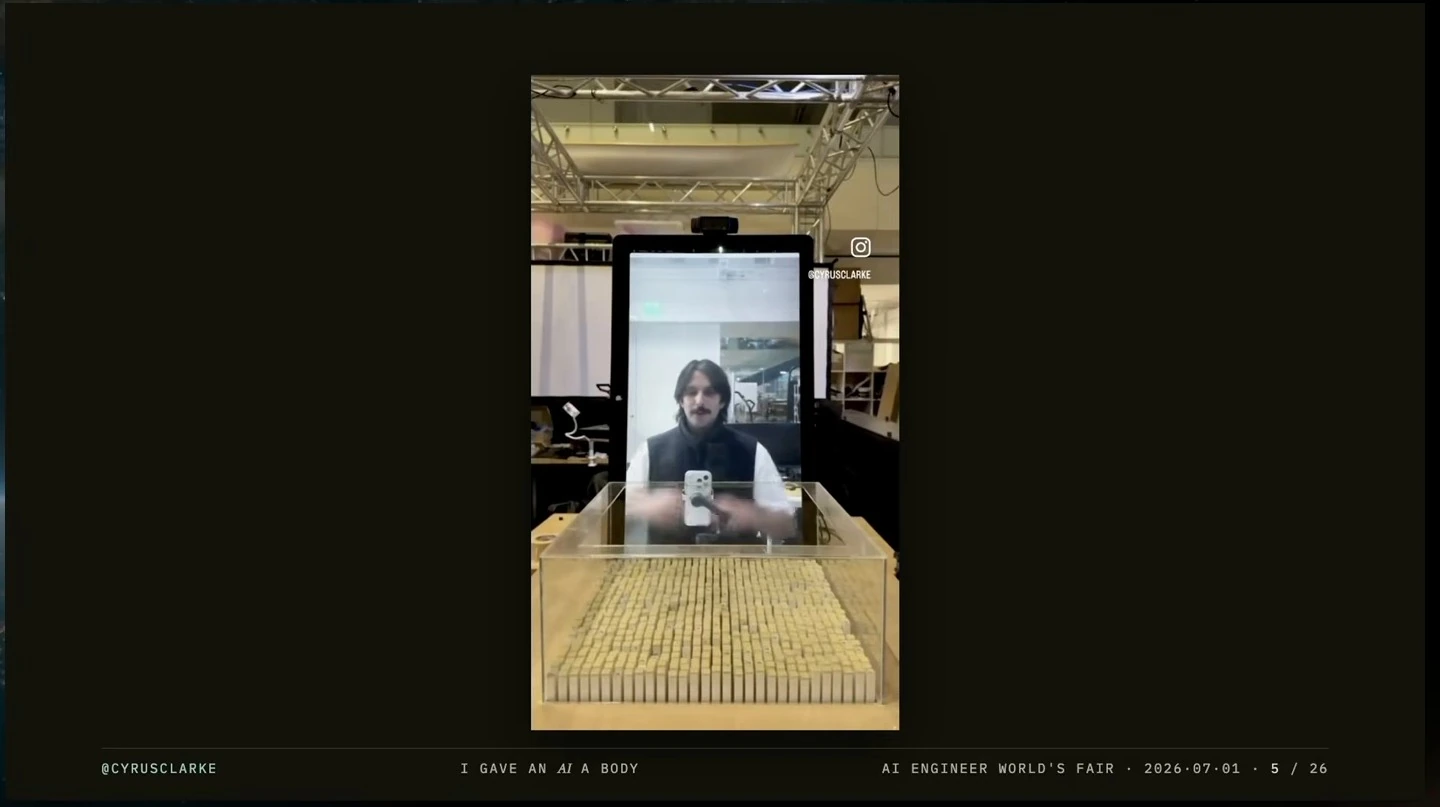A person appears on a screen behind a grid of actuating pins.